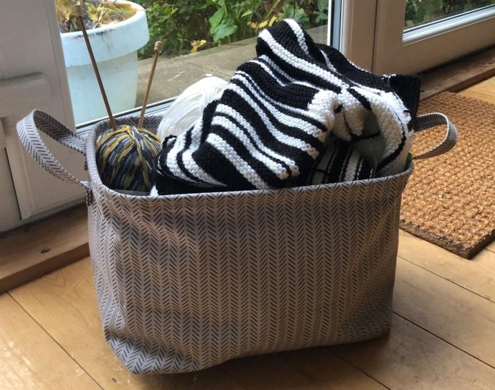 Knitting basket with wool and needles